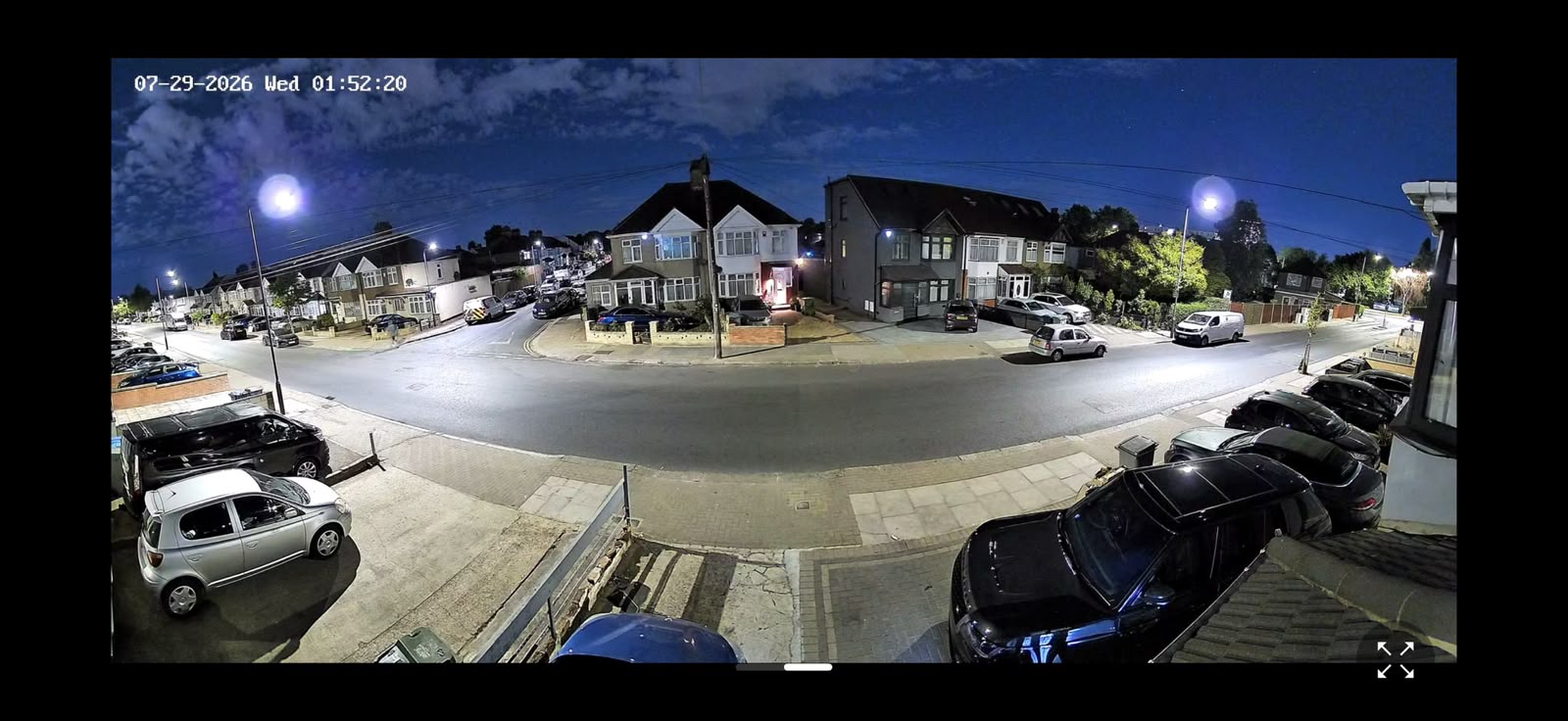 Wide view of a residential street captured at night