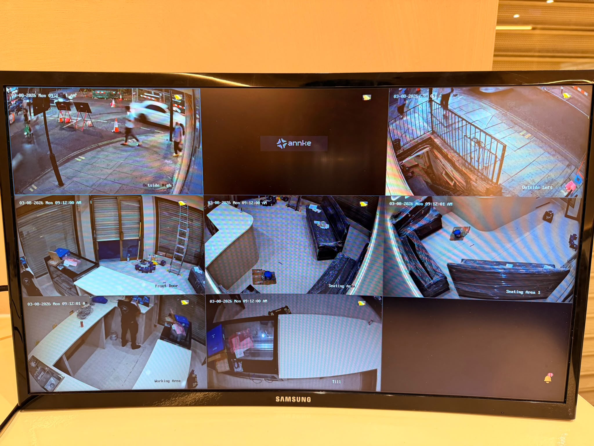 Multi-camera CCTV monitor showing several areas of a business